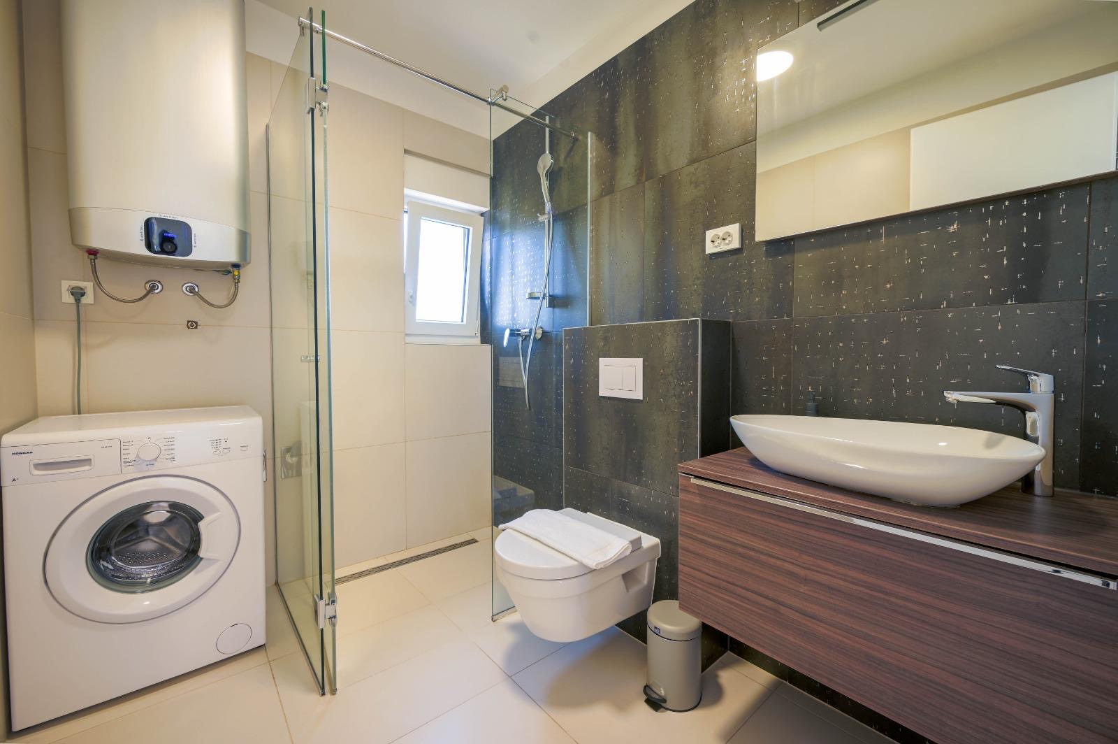 Bathroom with walk-in shower and washing machine